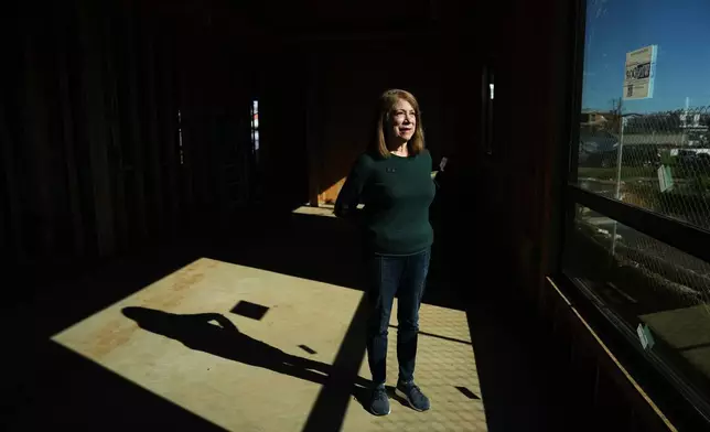 Gail Kass stands inside her home being rebuilt on the one-year anniversary of the Palisades Fire in the Pacific Palisades neighborhood of Los Angeles Wednesday, Jan. 7, 2026. (AP Photo/Jae C. Hong)