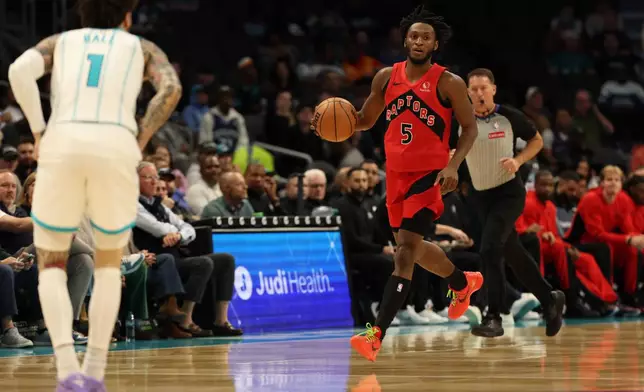 Toronto Raptors guard Immanuel Quickley (5) brings the ball up court towards Charlotte Hornets guard Lamelo Ball (1) during the first half of an NBA basketball game against the Charlotte Hornets, Wednesday, Jan. 7, 2026, in Charlotte, N.C. (AP Photo/Krista Jasso)