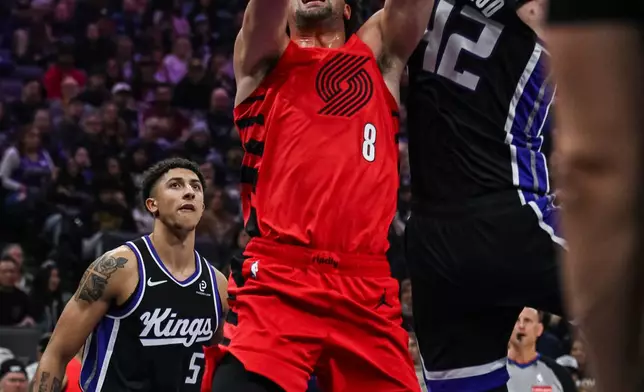 Portland Trail Blazers forward Deni Avdija (8) is fouled by Sacramento Kings center Maxime Raynaud (42) during the first half of an NBA basketball game, Sunday, Jan. 18, 2026, in Sacramento, Calif. (AP Photo/Justine Willard)