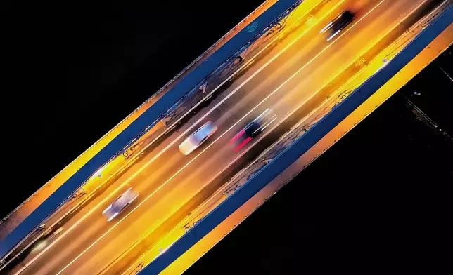 Cars drive on a bridge over the river Main in Frankfurt, Germany, Thursday, Jan. 15, 2026. (AP Photo/Michael Probst)