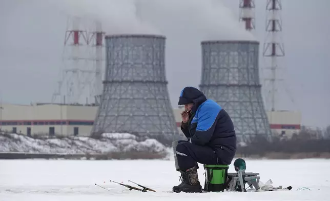 A man fishes on the ice of the Gulf of Finland in St. Petersburg, Russia, Thursday, Jan. 15, 2026. (AP Photo/Dmitri Lovetsky)