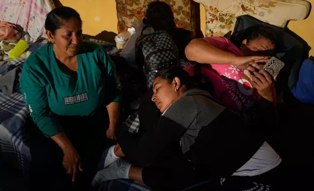 Mileidy Mendoza, center, waits at Zone 7 of the Bolivarian National Police, where her fiancé Eric Diaz is being held as a political detainee in Caracas, Venezuela, Sunday, Jan. 11, 2026, after the government announced prisoners would be released.(AP Photo/Matias Delacroix)