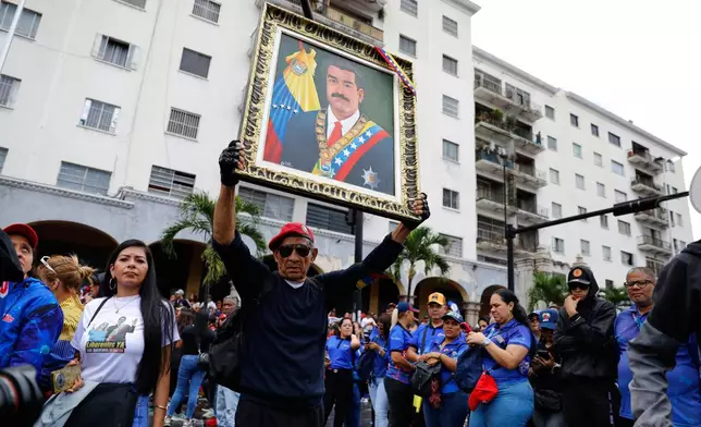 Supporters of former Venezuelan President Nicolas Maduro rally calling for his release as he faces trial in the United States after being captured by U.S. forces, in Caracas, Venezuela, Friday, Jan. 14, 2026. (AP Photo/Cristian Hernandez)