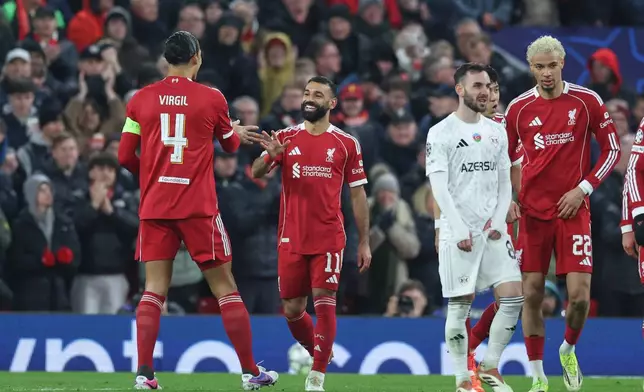 Liverpool's Mohamed Salah, centre, celebrates after scoring his side's third goal during the Champions League soccer match between Liverpool and Qarabag in Liverpool, Wednesday, Jan. 28, 2026. (AP Photo/Darren Staples)