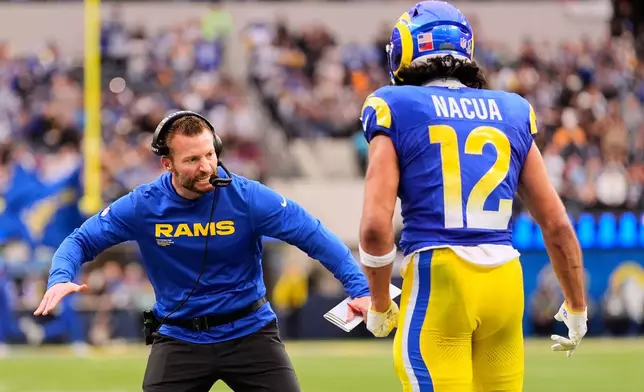 Los Angeles Rams wide receiver Puka Nacua (12) celebrates with head coach Sean McVay after his touchdown during the first half of an NFL football game against the Arizona Cardinals, Sunday, Jan. 4, 2026, in Inglewood, Calif. (AP Photo/Mark J. Terrill)