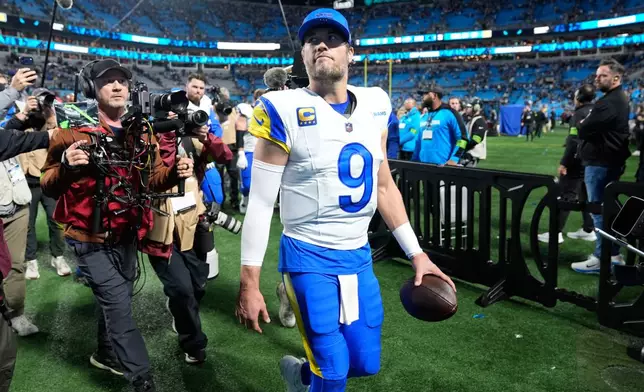 Los Angeles Rams quarterback Matthew Stafford (9) walks off the field after a win over the Carolina Panthers in an NFL wild-card playoff football game, Saturday, Jan. 10, 2026, in Charlotte, N.C. (AP Photo/Erik Verduzco)