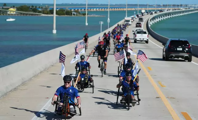 Wounded veterans ride over the Seven Mile Bridge in the annual Florida Keys Soldier Ride organized by the Wounded Warrior Project, Friday, Jan. 9, 2026, in Marathon, Fla. (AP Photo/Lynne Sladky)