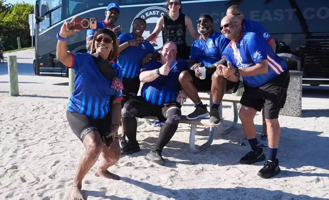 U.S. Army veteran Sabrina Bradley, left, takes a group photo at the Veterans Memorial Park after riding in the annual Florida Keys Soldier Ride organized by the Wounded Warrior Project, Friday, Jan. 9, 2026, in Little Duck Key, Fla. (AP Photo/Lynne Sladky)
