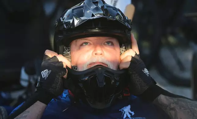 U.S. Marine Corps veteran Matthew Hannon adjusts his helmet before riding in the annual Florida Keys Soldier Ride organized by the Wounded Warrior Project, Friday, Jan. 9, 2026, in Key Largo, Fla. (AP Photo/Lynne Sladky)