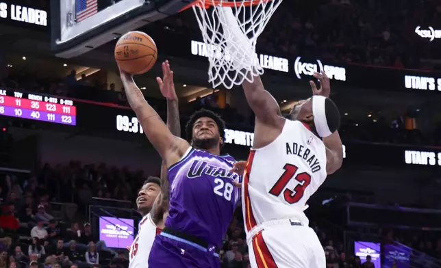 Utah Jazz forward Brice Sensabaugh (28) goes to the basket against Miami Heat center Bam Adebayo (13) during the second half of an NBA basketball game, Saturday, Jan. 24, 2026, in Salt Lake City. (AP Photo/Rob Gray)