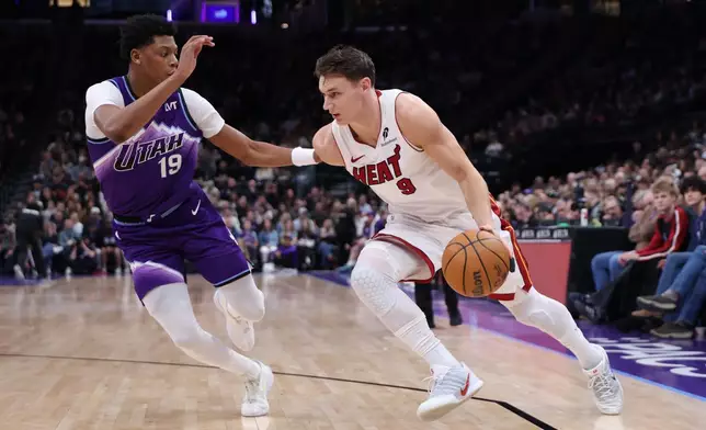 Miami Heat guard Pelle Larsson (9) drives to the basket against Utah Jazz guard Ace Bailey (19) during the first half of an NBA basketball game, Saturday, Jan. 24, 2026, in Salt Lake City. (AP Photo/Rob Gray)