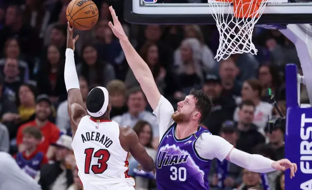 Miami Heat center Bam Adebayo (13) shoots the ball over Utah Jazz center Jusuf Nurkic (30) during the second half of an NBA basketball game, Saturday, Jan. 24, 2026, in Salt Lake City. (AP Photo/Rob Gray)