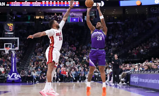 Utah Jazz forward Brice Sensabaugh (28) shots a three point basket over Miami Heat guard Norman Powell (24) during the second half of an NBA basketball game, Saturday, Jan. 24, 2026, in Salt Lake City. (AP Photo/Rob Gray)