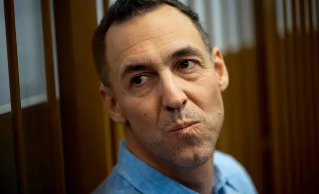 FILE - French citizen Laurent Vinatier sits in a cage prior to a court session at the Zamoskvoretsky District Court in Moscow, Oct. 14, 2024. (AP Photo/Pavel Bednyakov, File)