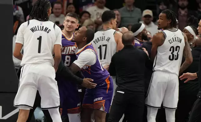 Phoenix Suns guard Grayson Allen (8) and Brooklyn Nets forward Ziaire Williams (1) get separated during the second half of an NBA basketball game, Tuesday, Jan. 27, 2026, in Phoenix. (AP Photo/Rick Scuteri)