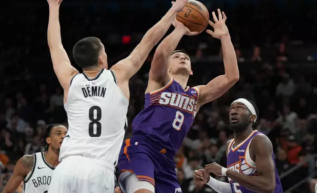 Phoenix Suns guard Grayson Allen (8) shoots on Brooklyn Nets guard Egor Demin (8) during the second half of an NBA basketball game, Tuesday, Jan. 27, 2026, in Phoenix. (AP Photo/Rick Scuteri)