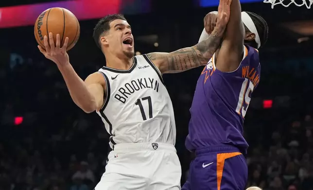 Brooklyn Nets forward Michael Porter Jr. shoots on Phoenix Suns center Mark Williams (15) during the first half of an NBA basketball game, Tuesday, Jan. 27, 2026, in Phoenix. (AP Photo/Rick Scuteri)