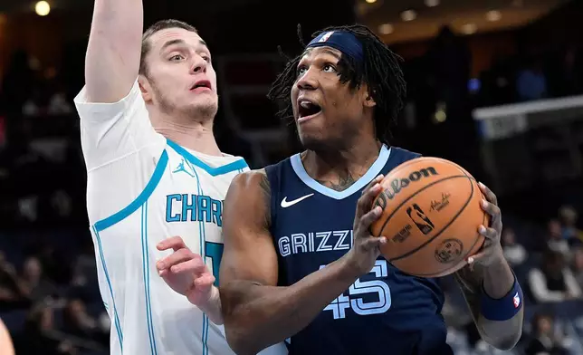 Memphis Grizzlies forward GG Jackson II (45) drives against Charlotte Hornets center Ryan Kalkbrenner in the second half of an NBA basketball game, Wednesday, Jan. 28, 2026, in Memphis, Tenn. (AP Photo/Brandon Dill)