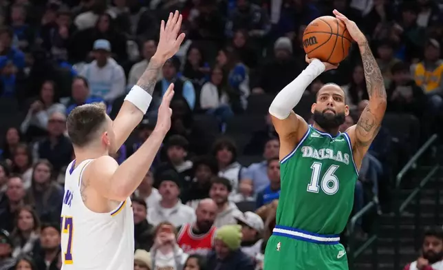 Dallas Mavericks forward Caleb Martin (16) shoots against Los Angeles Lakers guard Luka Doncic during the second half of an NBA basketball game Saturday, Jan. 24, 2026, in Dallas. (AP Photo/Julio Cortez)
