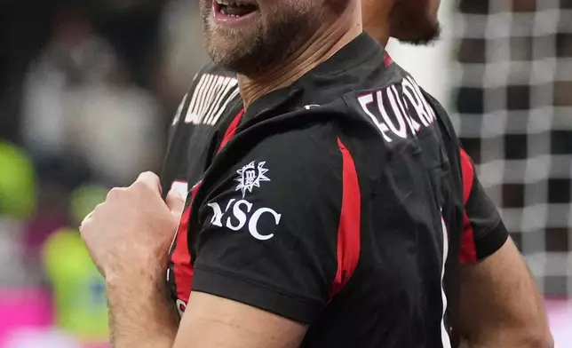 AC Milan's Niclas Fullkrug celebrates after scoring his side's first goal during the Serie A soccer match between AC Milan and Lecce in Milan, Italy, Sunday, Jan. 18, 2026. (AP Photo/Antonio Calanni)