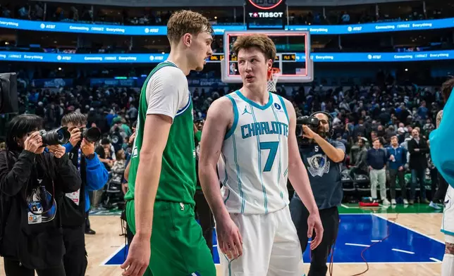 Dallas Mavericks forward Cooper Flagg, center left, and Charlotte Hornets guard Kon Knueppel (7) talk after an NBA basketball game, Thursday, Jan. 29, 2026, in Dallas. (AP Photo/Jessica Tobias)
