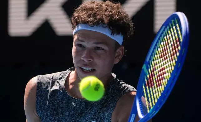 Ben Shelton of the U.S. plays a forehand return to Ugo Humbert of France during their first round match at the Australian Open tennis championship in Melbourne, Australia, Tuesday, Jan. 20, 2026. (AP Photo/Asanka Brendon Ratnayake)