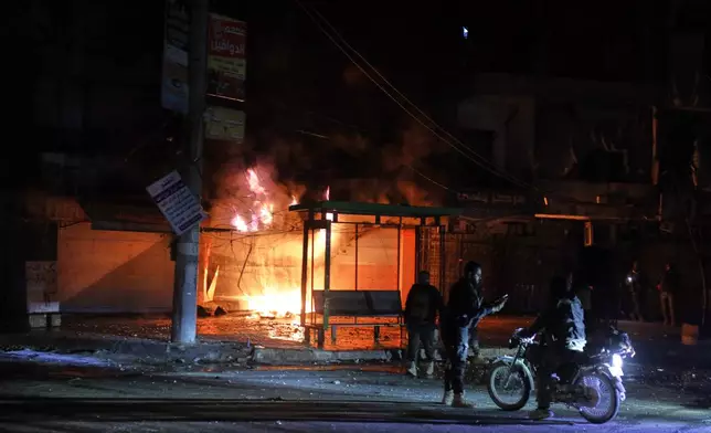 Members of Syrian government forces deploy on the streets as they take over the Achrafieh neighborhood from Kurdish fighters during ongoing clashes that erupted Tuesday in a contested area of the northern city of Aleppo, Syria, Thursday, Jan. 8, 2026. (AP Photo/Omar Albam)