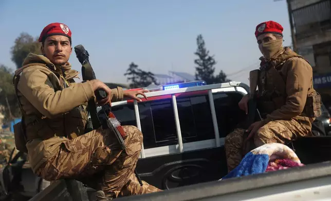 Members of Syrian government forces deploy on the streets as they take over the Achrafieh neighborhood from Kurdish fighters after three days of clashes in a contested area of the northern city of Aleppo, Syria, Friday, Jan. 9, 2026. (AP Photo/Ghaith Alsayed)