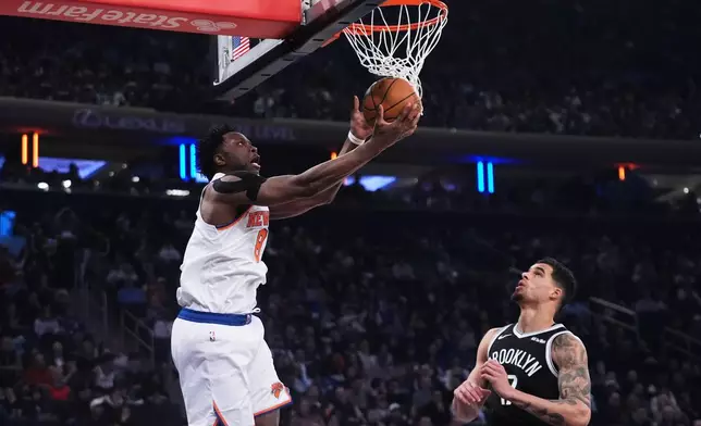 New York Knicks' OG Anunoby, left, shoots over Brooklyn Nets' Michael Porter Jr. during the first half of an NBA basketball game Wednesday, Jan. 21, 2026, in New York. (AP Photo/Frank Franklin II)