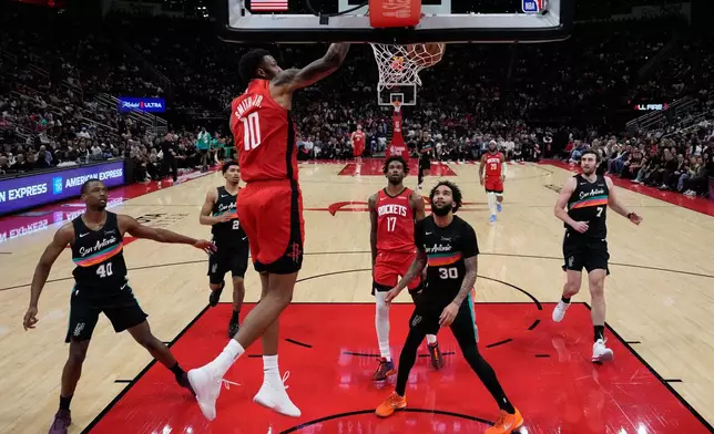 Houston Rockets forward Jabari Smith Jr. (10) dunks during the first half of an NBA basketball game against the San Antonio Spurs in Houston, Tuesday, Jan. 20, 2026. (AP Photo/Ashley Landis)