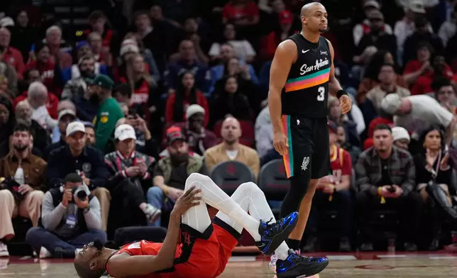 Houston Rockets forward Kevin Durant (7) reacts after a collision with San Antonio Spurs forward Keldon Johnson (3) during the first half of an NBA basketball game in Houston, Tuesday, Jan. 20, 2026. (AP Photo/Ashley Landis)