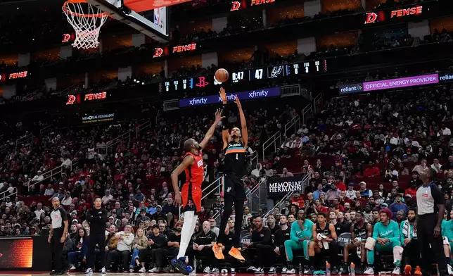 San Antonio Spurs forward Victor Wembanyama (1) shoots against Houston Rockets forward Kevin Durant (7) during the first half of an NBA basketball game in Houston, Tuesday, Jan. 20, 2026. (AP Photo/Ashley Landis)