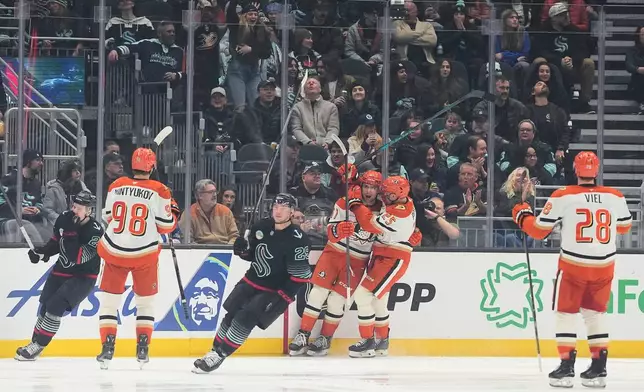 Anaheim Ducks left wing Cutter Gauthier, fourth from left, celebrates his goal with center Ryan Poehling (25) and left wing Jeffrey Viel (28) as Seattle Kraken right wing Eeli Tolvanen, left, and defenseman Vince Dunn (29) skate away during the first period of an NHL hockey game Friday, Jan. 23, 2026, in Seattle. (AP Photo/Lindsey Wasson)
