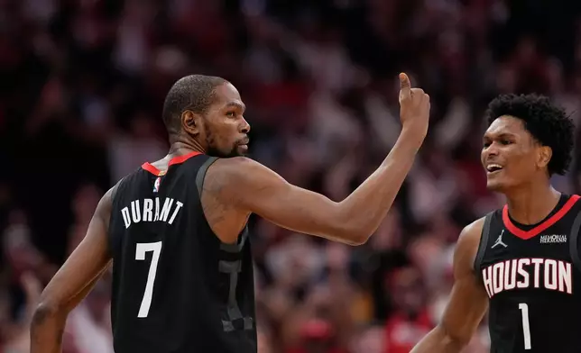 Houston Rockets' Kevin Durant (7) celebrates with Amen Thompson (1) after making a game-winning 3-point basket against the Phoenix Suns during the second half of an NBA basketball game Monday, Jan. 5, 2026, in Houston. (AP Photo/David J. Phillip)