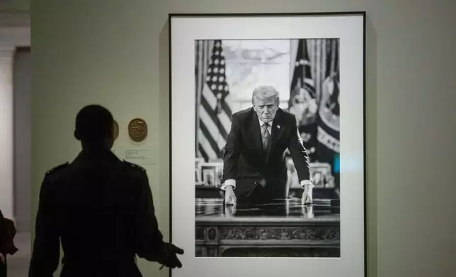 Visitors to the National Portrait Gallery walk past the portrait of President Donald Trump, Sunday, Jan. 11, 2026, in Washington. (AP Photo/Rod Lamkey, Jr.)