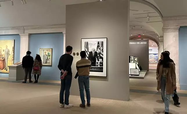 A photograph of President Donald Trump and a short plaque next to it are on display at the Smithsonian's National Portrait Gallery's "American Presidents" exhibit on Sunday, Jan. 11, 2026 in Washington. (AP Photo/Anna Johnson)