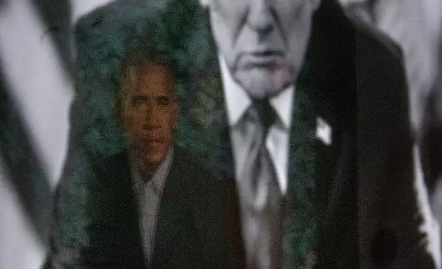 A reflection of the portrait of former President Barack Obama is seen in a photograph of President Donald Trump on display at the Smithsonian's National Portrait Gallery's "American Presidents" exhibit on Sunday, Jan. 11, 2026 in Washington. (AP Photo/Rod Lamkey, Jr.)