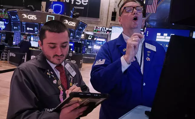 Trader Drew Cohen,; left, and Specialist Patrick King work on the floor of the New York Stock Exchange, Thursday, Jan. 22, 2026. (AP Photo/Richard Drew)