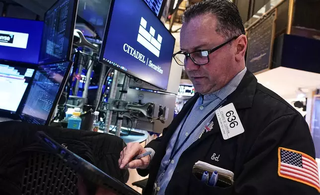 Trader Edward Curran works on the floor of the New York Stock Exchange, Thursday, Jan. 22, 2026. (AP Photo/Richard Drew)