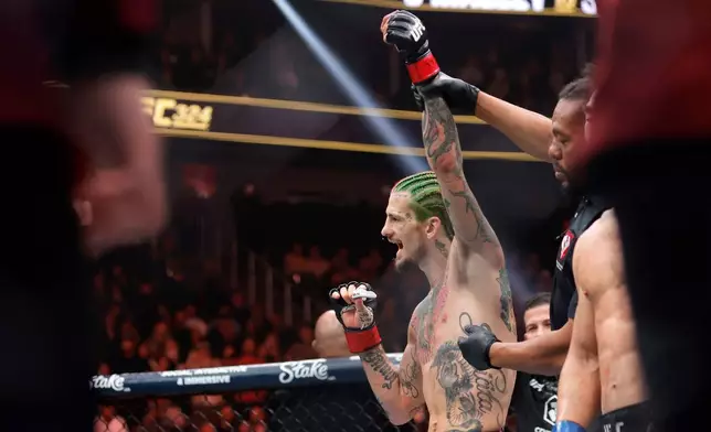 Sean O'Malley, left, is declared the winner over Song Yadong in a bantamweight bout during the UFC 324 mixed martial arts event Saturday Jan. 24, 2026, in Las Vegas. (AP Photo/Steve Marcus)