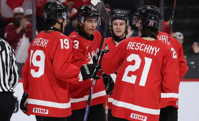 Canada forward Sam O'Reilly (23) celebrates with teammates after a power play goal against Finland during the second period of an IIHF World Junior Hockey Championship bronze medal game, Monday, Jan. 5, 2026, in St. Paul, Minn. (AP Photo/Matt Krohn)