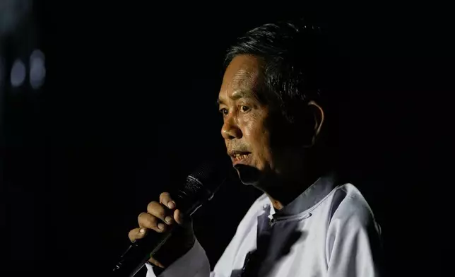 An official of the Union Election Commission announces the open of a polling station during the third phase of general election in Mandalay, central Myanmar, Sunday, Jan. 25, 2026. (AP Photo/Aung Shine Oo)