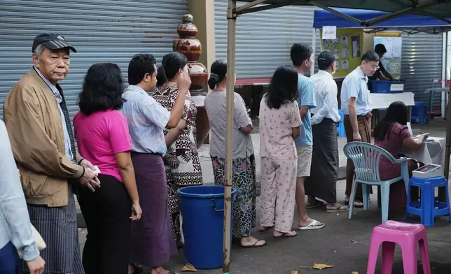 Voters line up to cast ballots at a polling station during the final round of general election Sunday, Jan. 25, 2026, in Yangon, Myanmar. (AP Photo/Thein Zaw)