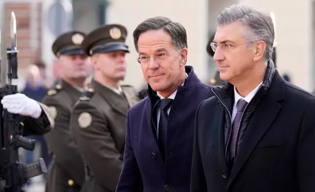 NATO Secretary General Mark Rutte, center, is welcomed by Croatian Prime Minister Andrej Plenkovic, in Zagreb, Croatia, Monday, Jan. 12, 2026. (AP Photo/Darko Bandic)