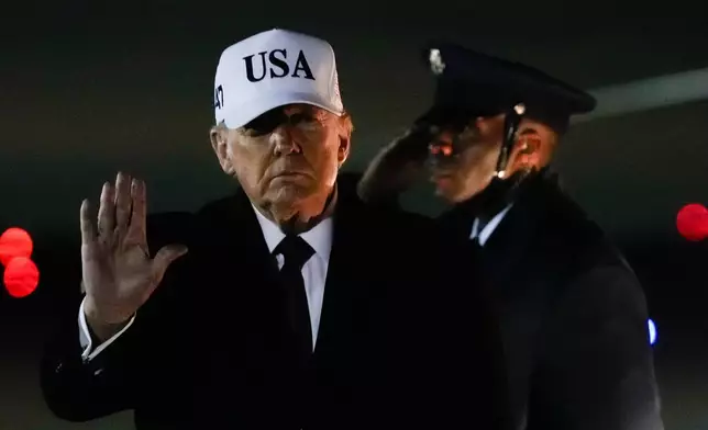 President Donald Trump waves after arriving on Air Force One from Florida, Sunday, Jan. 11, 2026, at Joint Base Andrews, Md. (AP Photo/Julia Demaree Nikhinson)