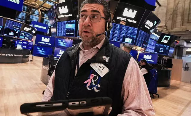 Trader Michael Capolino works on the floor of the New York Stock Exchange, Friday, Jan. 2, 2026. (AP Photo/Richard Drew)