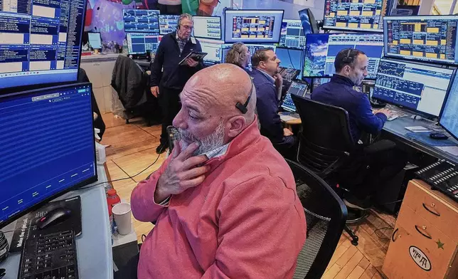 Trader Vincent Napolitano, foreground, works with colleagues on the floor of the New York Stock Exchange, Friday, Jan. 2, 2026. (AP Photo/Richard Drew)