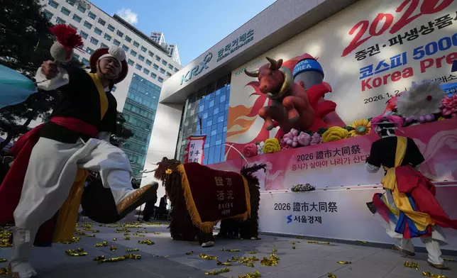 Dancers in traditional costumes perform to celebrate the opening for the 2026 trading year outside of the Korea Exchange in Seoul, South Korea, Friday, Jan. 2, 2026. (AP Photo/Lee Jin-man)
