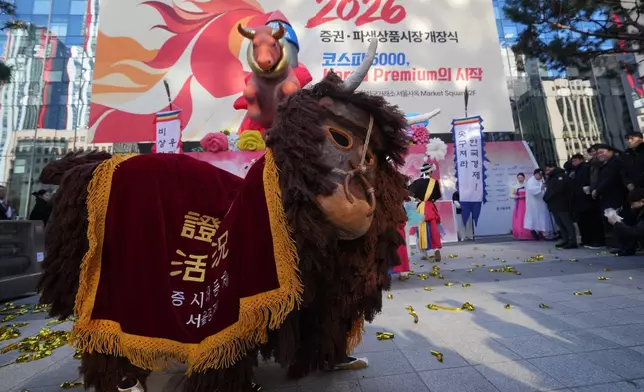Dancers in a bull-shaped costume perform to celebrate the opening for the 2026 trading year outside of the Korea Exchange in Seoul, South Korea, Friday, Jan. 2, 2026. (AP Photo/Lee Jin-man)