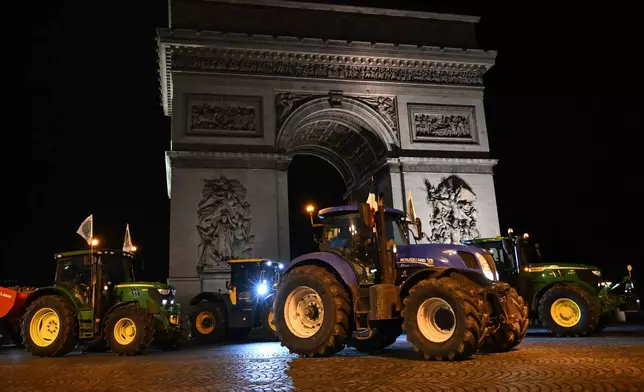 Farmers drive their tractors past the Arc de Triomphe as they protest the Mercosur trade deal, Tuesday, Jan. 13, 2026 in Paris. (AP Photo/Emma Da Silva)